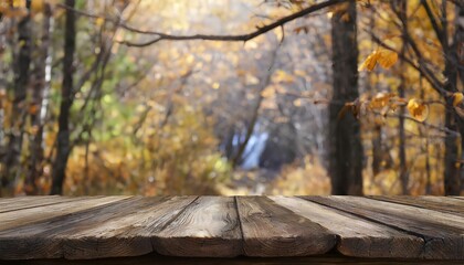 Naklejka na ściany i meble rustic wooden table for product display with blur background of autumn forest.
