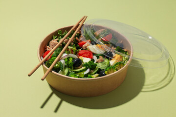 Salad with tuna on a green background.
