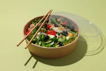  Salad with tuna on a green background. © Atlas