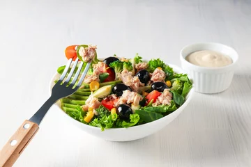  Salad with tuna on a white table. © Atlas