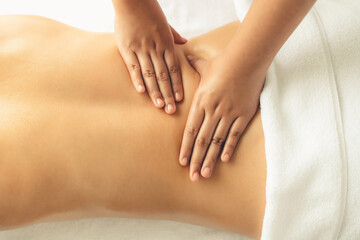 Closeup woman customer enjoying relaxing anti-stress spa massage and pampering with beauty skin...