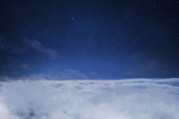 Beautiful starry sky space with clouds, concept. Traveling above the clouds. Flight