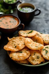 Naklejka premium Closeup Image of Delicious Indian Crunchy Kachori with Sauce Served on Plate, Ready to be Eaten and Enjoyed.
