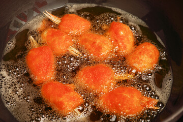 Crab claws frying in a pan