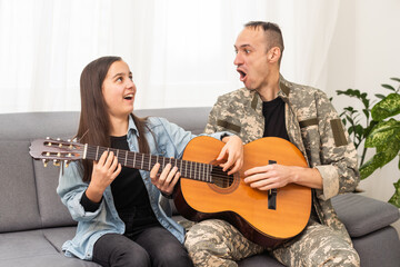 a veteran and his daughter play the guitar