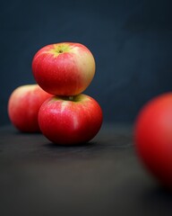Vertical shot of red apples on a dark surface