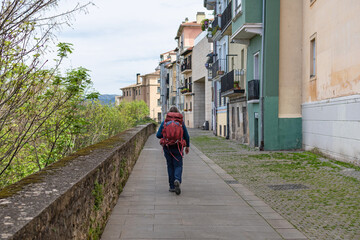 Fototapeta na wymiar Pilgrim walking along the walls of Pamplona. Way of St. James