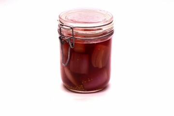 Closeup shot of pickled onions in a jar isolated on a white background