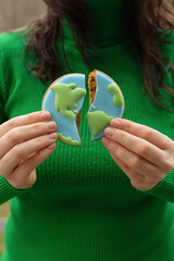 Broken cookies in the shape of the earth. Earth Day concept. Environmental problem. - 782919459