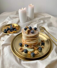 Vertical shot of pancakes on a white plate with 
condensed milk and blueberries and walnuts on it