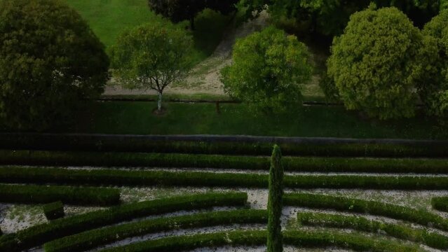 Bird's eye view of a green labyrinth garden in Ames, Spain