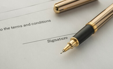 pen on a document. Image of the signature part of a document and pen