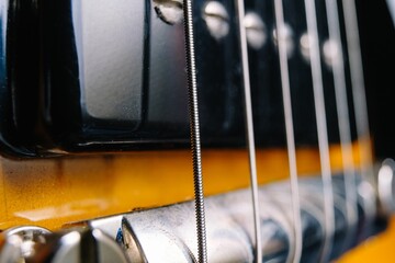 Closeup shot of a classical acoustic guitar strings and the bridge