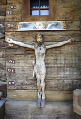 Wooden sculpture of Jesus (crucifixion) on the wooden wall