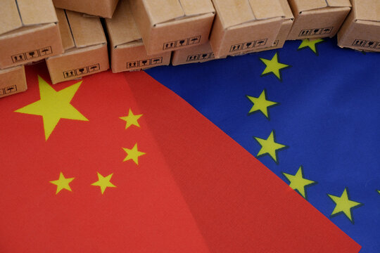 China and European Union trading. EU and Chinese flags with many carton boxes.