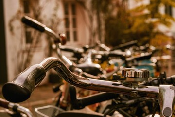 Selective focus shot of metallic handlebars of bikes against blurred background