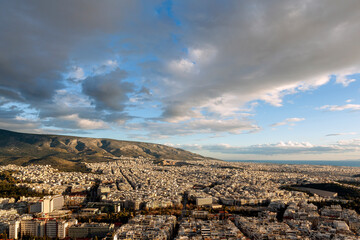Majestic sunset with marvellous clouds over Hymettus mount and Athens city, Greece. There are several districts included like Ilioupoli, Pagkrati, Ilisia, Hilton, Kesariani, Vyronas and Kareas. 