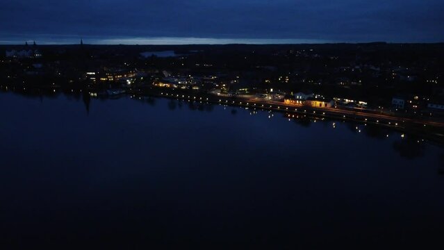 Scenic view of illuminated buildings reflecting in the tranquil lake in Plon, Germany at night
