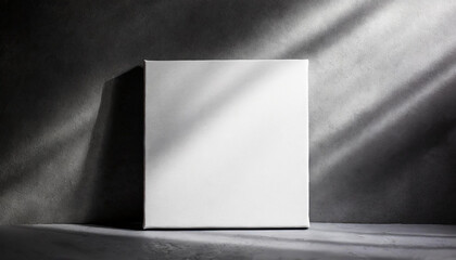 Mock-up of white square canvas on dark gray background. Blank poster.