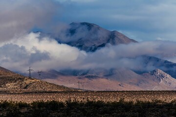 Scenic shot of hills covered in fog and clouds