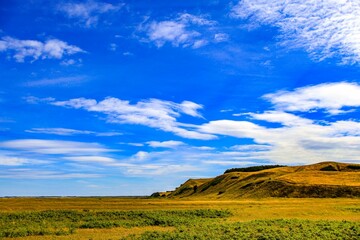 Beautiful scene of the landscape with yellow fields and hills under a blue sky