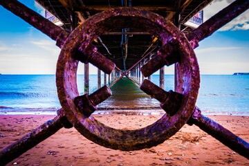 Beautiful shot below wooden Penarth Pier on the sand by wate in Torquay, Torbay, UK