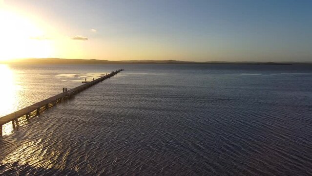 Aerial view of a wooden dock going out into the Tuggerah Lake in Australia
