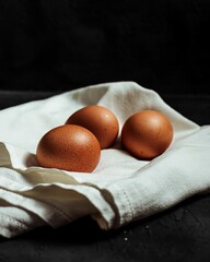 Vertical shot of fresh eggs on a towel