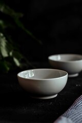 Vertical shot of two white ceramic bowls