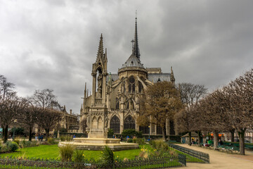 Notre dame in Paris, France against a clouded sky