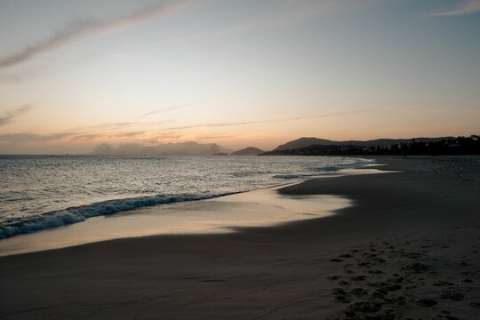 Beautiful shot of Camboinhas beach and sea with mountain in the background at sunset