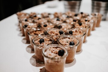 Closeup shot of a tasty dessert with blueberries in small glass cups on a table