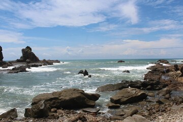 Beautiful shot of a seascape with rocks under the clouds
