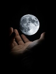 Vertical shot of a glowing breathtaking illustrative moon floating above the hand of a person