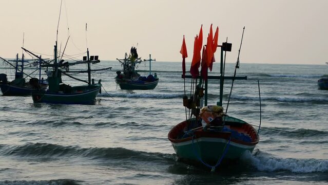 A lot of small fishing boats. fishing port of the villagers. The golden light reflects the water during the sunset.