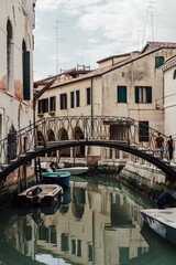 Vertical shot of a bridge over a canal in an old town
