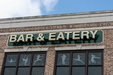 Obraz premium Bar and eatery sign on the building