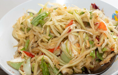 papaya salad on a white plate