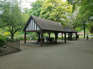 View of wooden pavilions with benches in the park