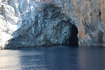 Aerial view of Lipari horse cave surrounded by water in Sicily