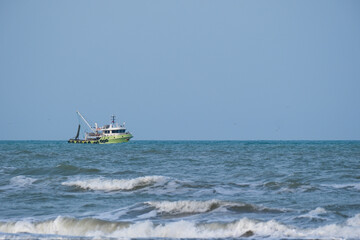 Fishing boat sailing in rough seas