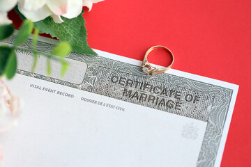 Naklejka premium Canadian Certificate of registration of marriage blank document and wedding ring close up