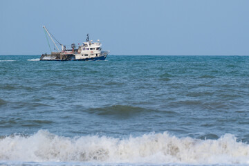 Fishing boat sailing in rough seas