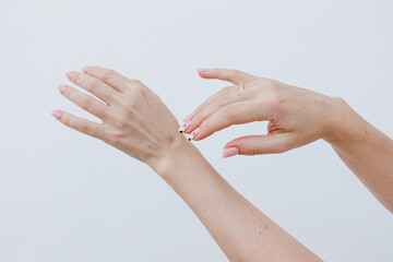 Female hands above white background