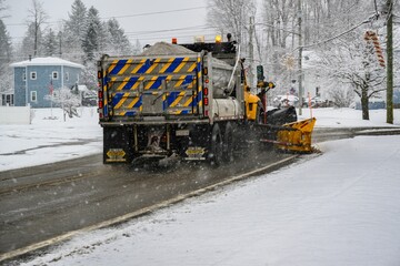 Beautiful view of a snow plow truck on a road on a cold winter day