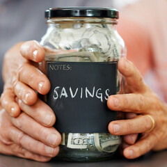 Married hands, money and mason jar for insurance, retirement or savings plan. Senior couple, cash or bills for pension, banking or investing together and generational wealth opportunity for family