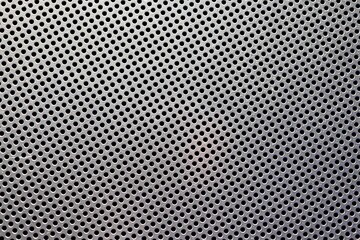 Background of grey metal with holes.