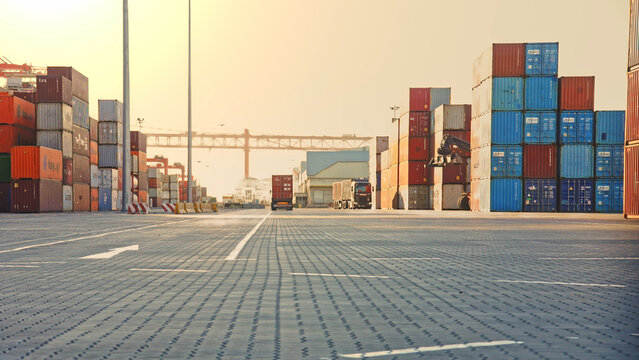 Truck unload many red intermodal containers time lapse. Busy port terminal. Export import heavy ship cargo. Transport logistic shipment. Load freight into dock. Lots of blue huge box rows. Stock line.