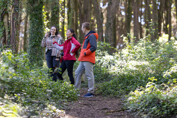 Group of People Walking Through a Forest
