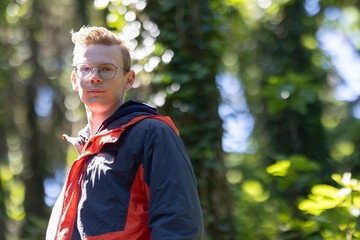 Man With Glasses Standing in the Woods